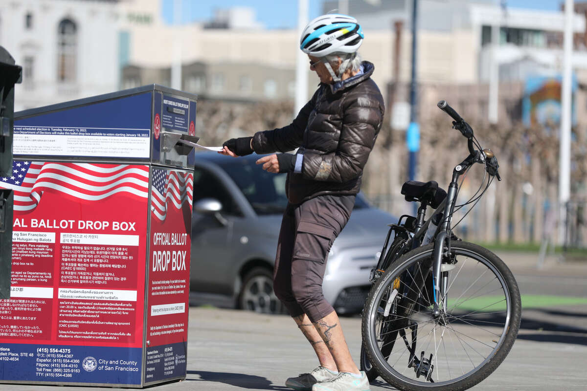 Voters drop their ballots into an official ballot drop box outside San Francisco City Hall during a special election in San Francisco, Calif. on Feb. 15, 2022.