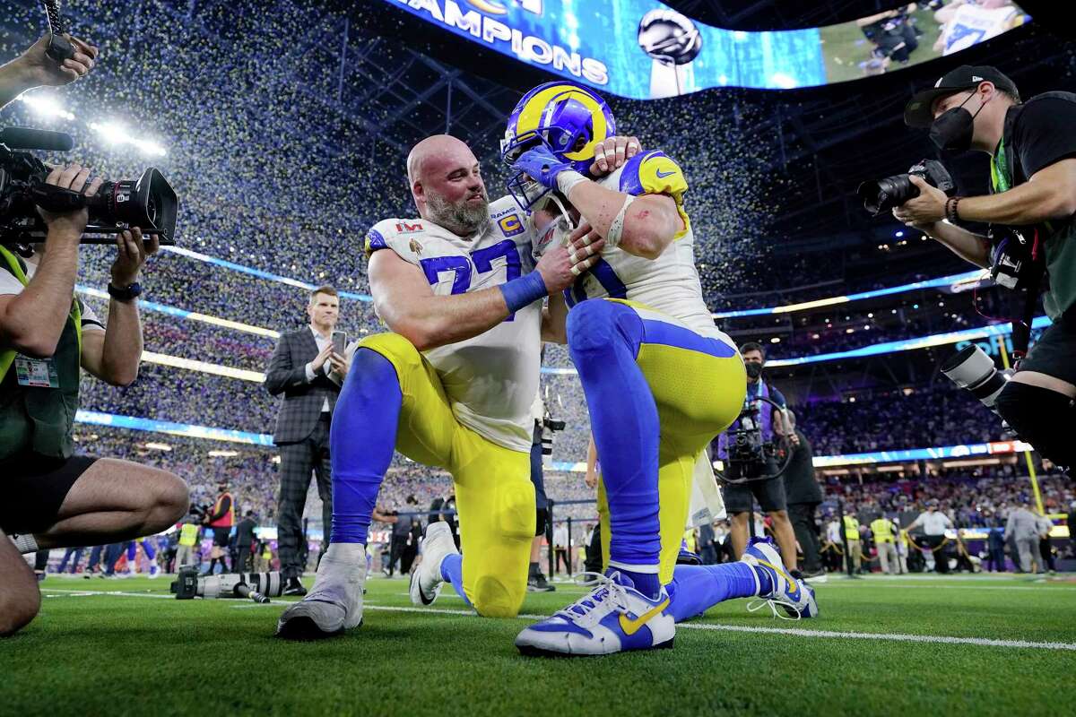 Los Angeles Rams offensive tackle Andrew Whitworth (77) and Los Angeles Rams wide receiver Cooper Kupp (10) celebrate after defeating the Cincinnati Bengals at the NFL Super Bowl 56 football game Sunday, Feb. 13, 2022, in Inglewood, Calif. (AP Photo/Steve Luciano)