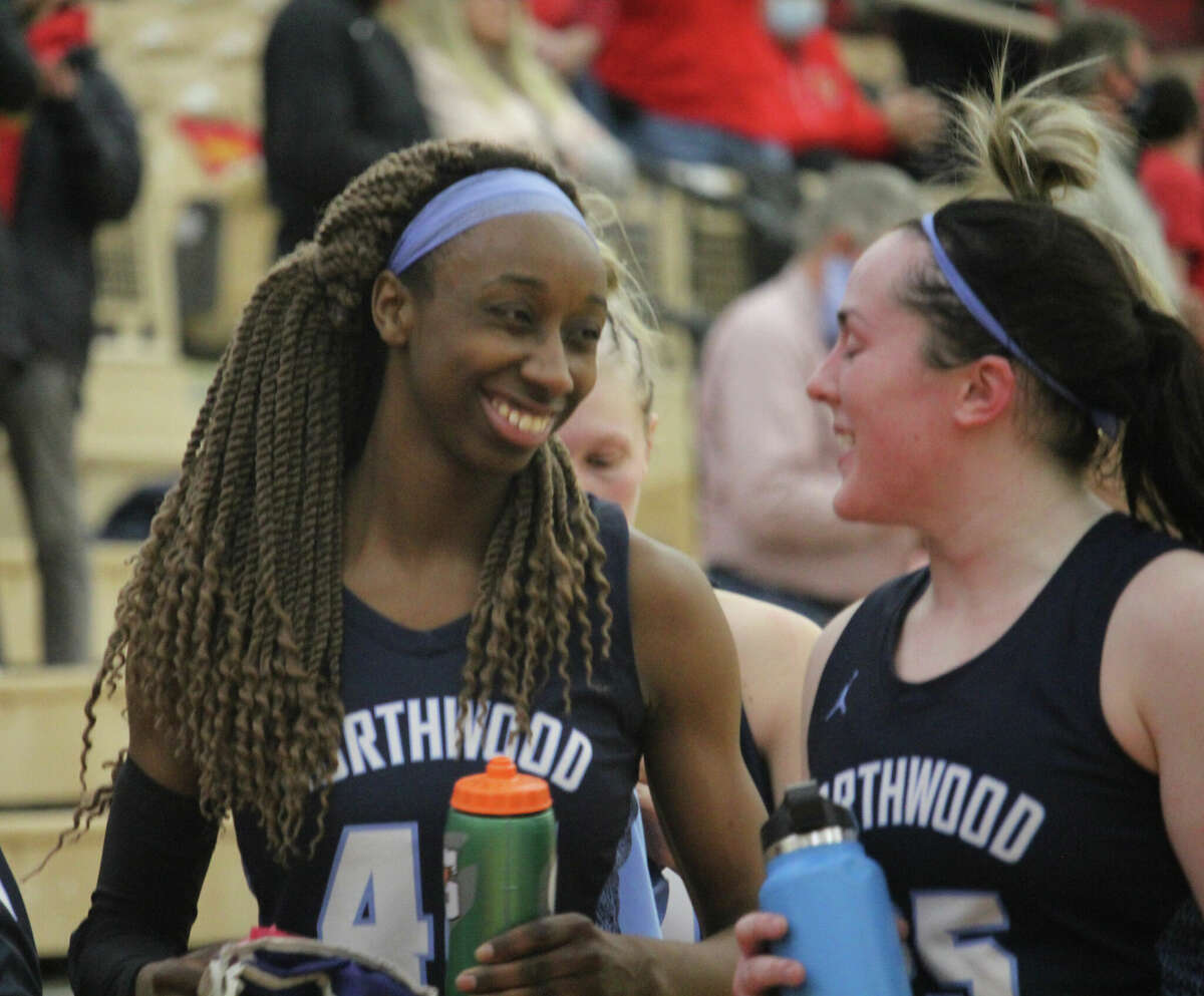 Big Rapids native Jayla Strickland (left) chats with a teammate after Monday's Northwood game at Ferris.