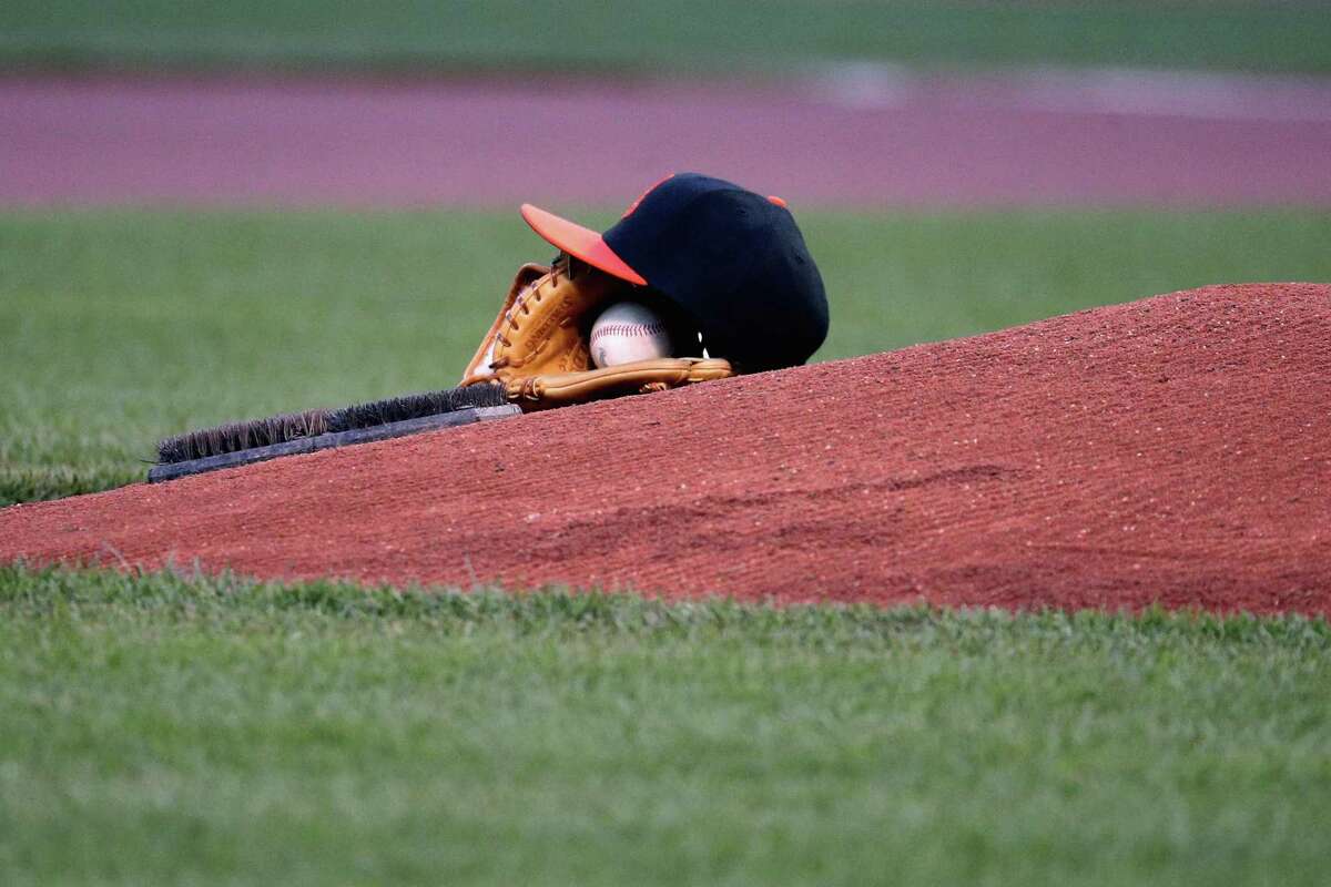 BALTIMORE, MARYLAND - APRIL 08: The cap and glove of starting pitcher Chris Tillman #30 of the Baltimore Orioles sit on the mound during the national anthem before the start of the Orioles game against the Tampa Bay Rays at Oriole Park at Camden Yards on April 8, 2016 in Baltimore, Maryland. (Photo by Rob Carr/Getty Images)