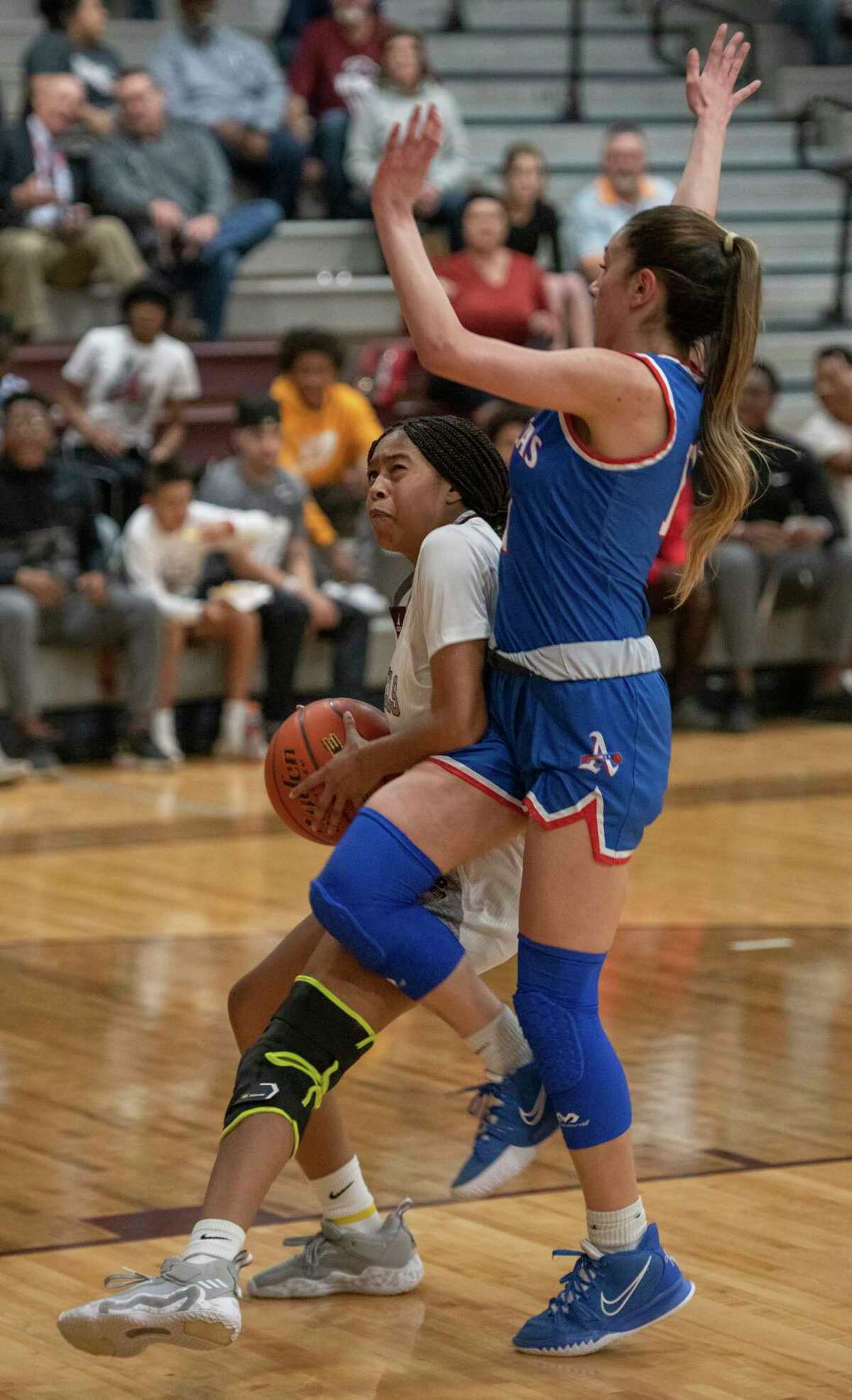 Legacy's Sa'Nya Green is fouled by El Paso Americas' Isabel Dempsey as she puts up a shot 02/15/2022 at the Rebel Gymnasium. Tim Fischer/Reporter-Telegram