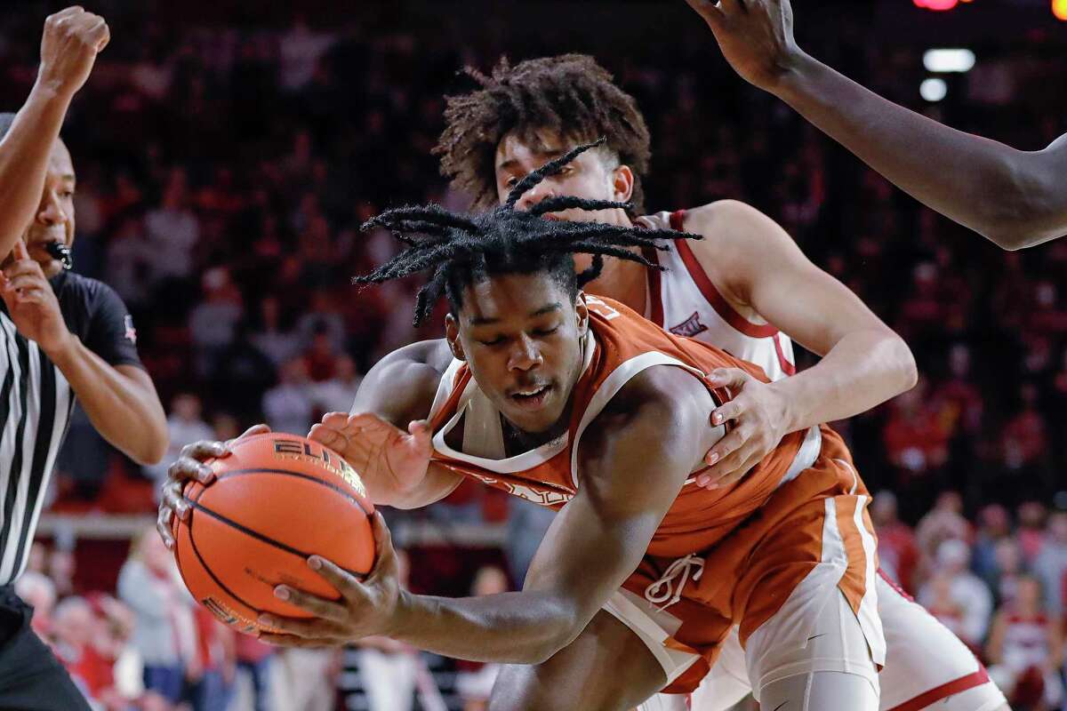 Oklahoma forward Jalen Hill fouls Texas guard Marcus Carr from behind in overtime. Carr had six of his 16 points in OT.