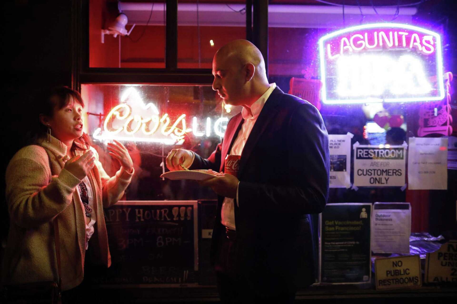 San Francisco Supervisor Bilal Mahmood, then a candidate for a state assembly seat, speaks with a constituent, during an election watch party at Red’s Place on 