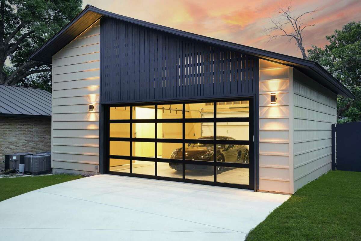 The second garage echoes design elements from the midcentury-style house. At night, inside lighting emits a gentle glow through glass doors. The $100,000 space accommodates two vehicles and offers plenty of storage.