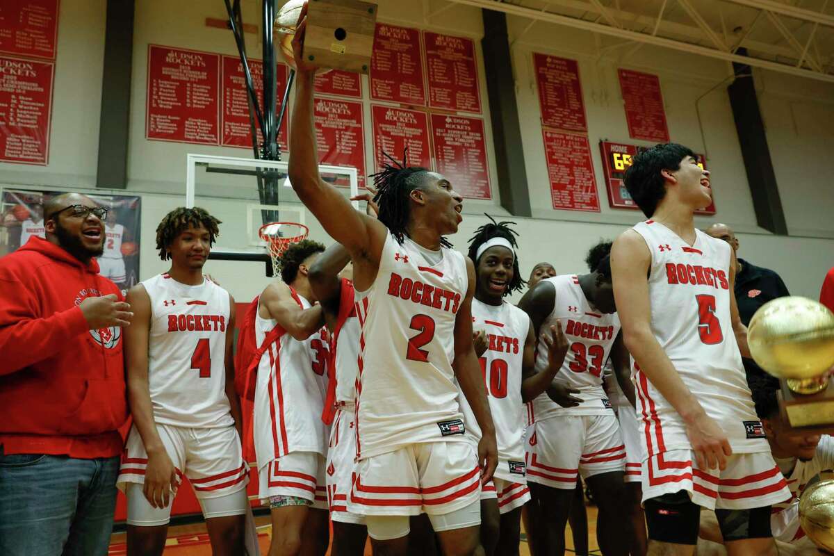 Judson’s Anariss Brandon (2) hoists a trophy to celebrate the Rockets’ 69-58 win over the Wagner Thunderbirds at Judson High School in San Antonio, Texas, Tuesday, Feb. 15, 2022. The Rockets win allowed them to secure the 27-6A championship title.