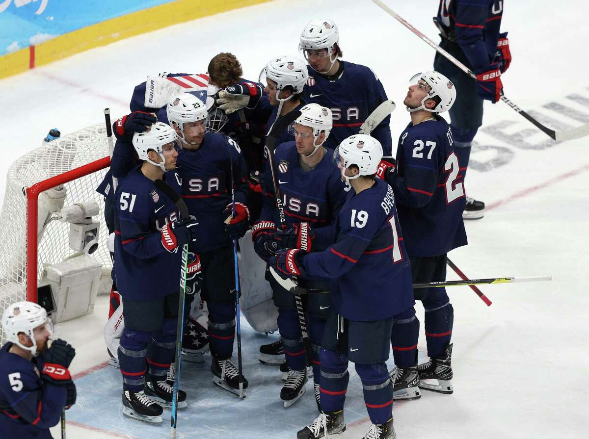 BEIJING, CHINA - FEBRUARY 16: Team United States players gather together around goaltender Strauss Mann #31after their shoot out loss during the Men’s Ice Hockey Quarterfinal match between Team United States and Team Slovakia on Day 12 of the Beijing 2022 Winter Olympic Games at National Indoor Stadium on February 16, 2022 in Beijing, China.
