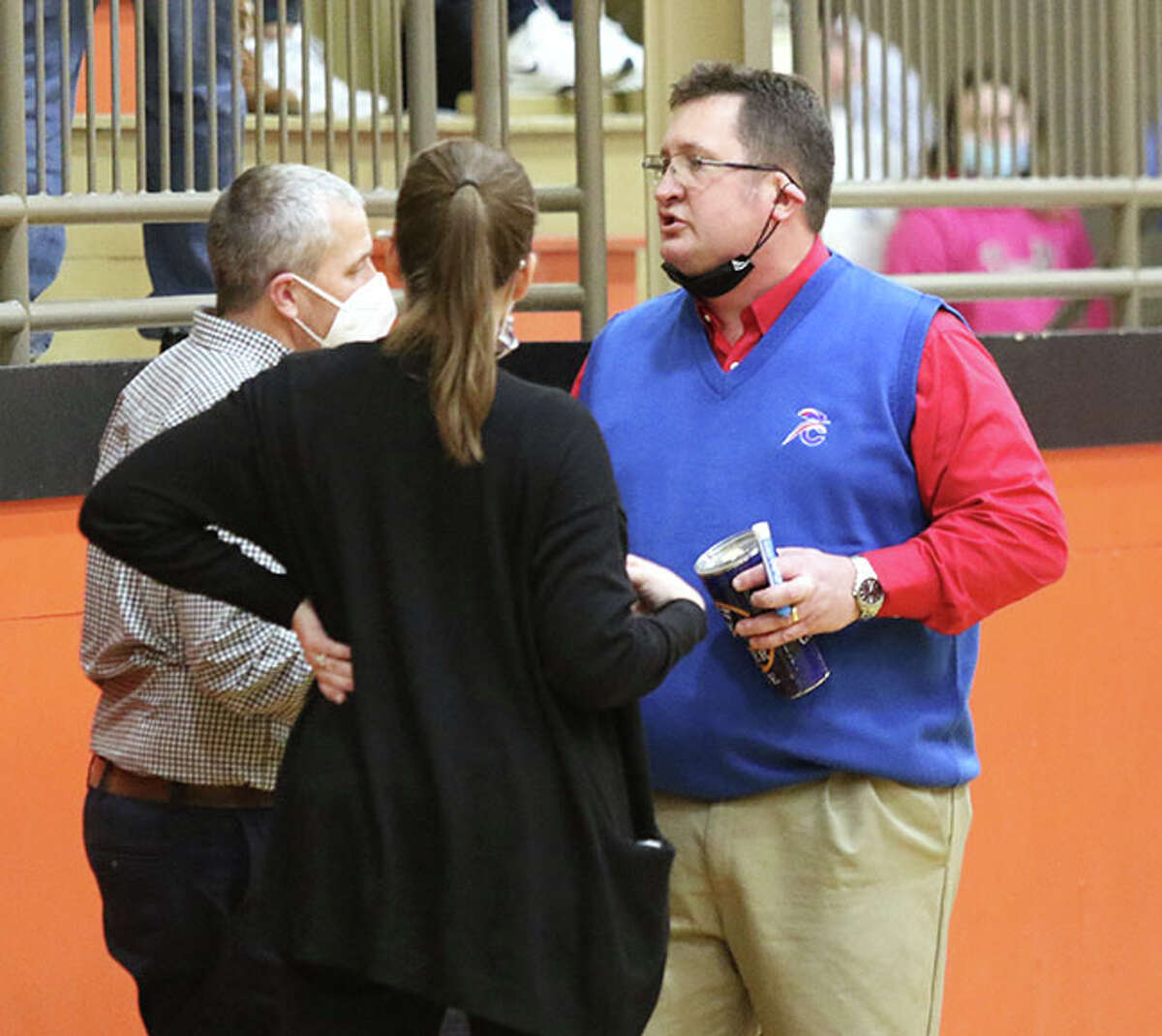Carlinville coach Darrin DeNeve (right) talks with assistants John Reels (left) and Renee Rehkemper at halftime of the title game at the Macoupin County Tourney earlier this season in Gillespie. The Cavaliers rallied in the fourth quarter Tuesday night to beat South County in the Hillsboro Class 2A Regional.