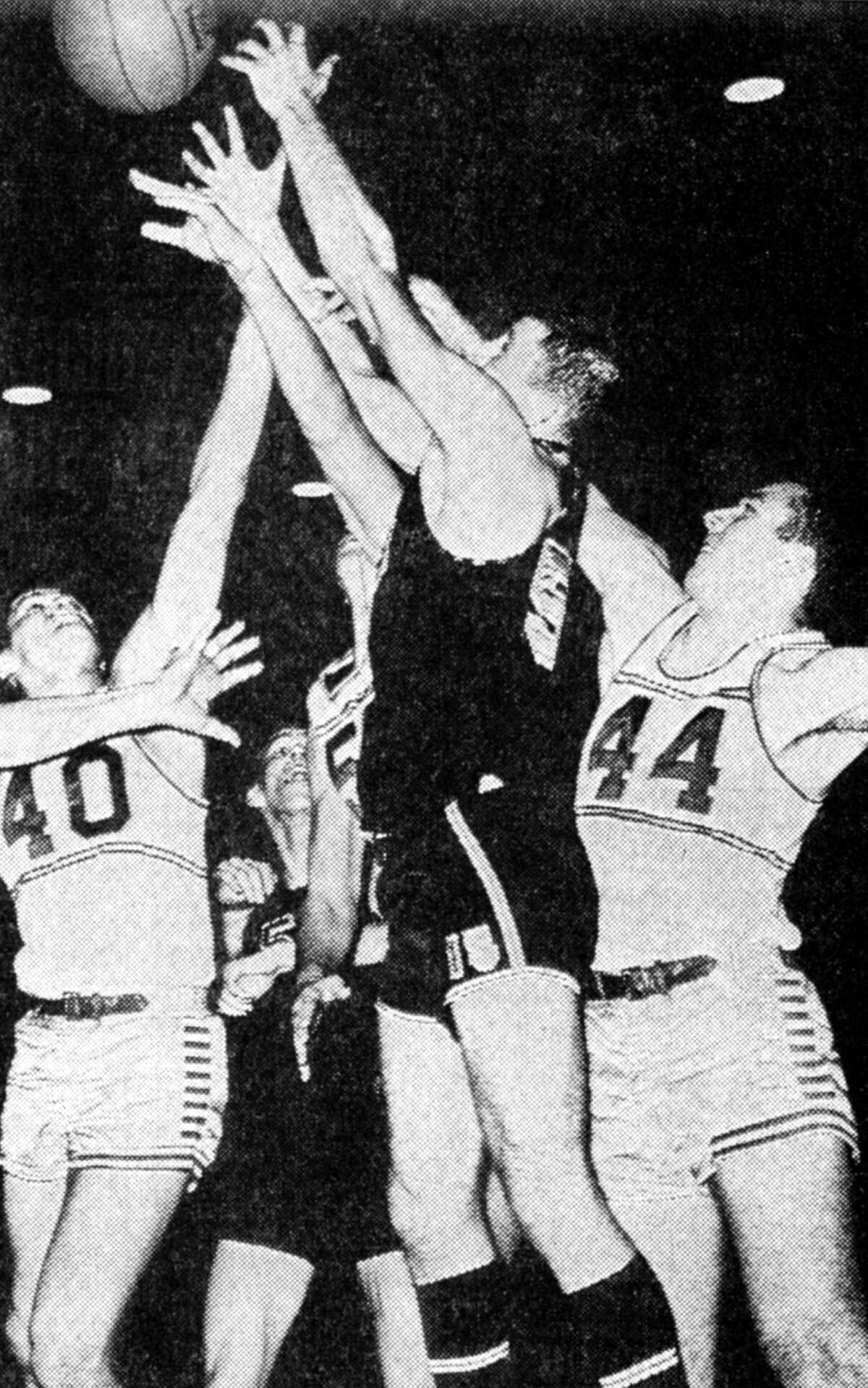 Manistee High School Chippewa players Dennis Lynch (No. 44) and Jim Wisniski (No. 40) go after a rebound in Friday night's game with the Alma Panthers which Manistee won by a score of 64-35. The photo was published in the News Advocate on Feb. 17, 1962.