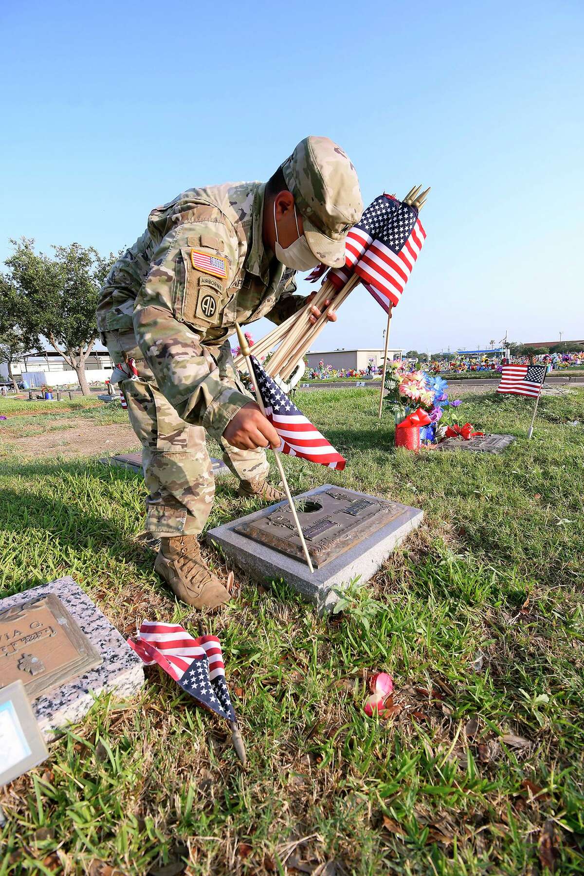 With Memorial Day being celebrated Monday, National Guardsman Sgt. Raymond Martinez, replaced American Flags on the graves of fallen veterans at the Calvary Catholic Cemetery on Friday, May 22, 2020.