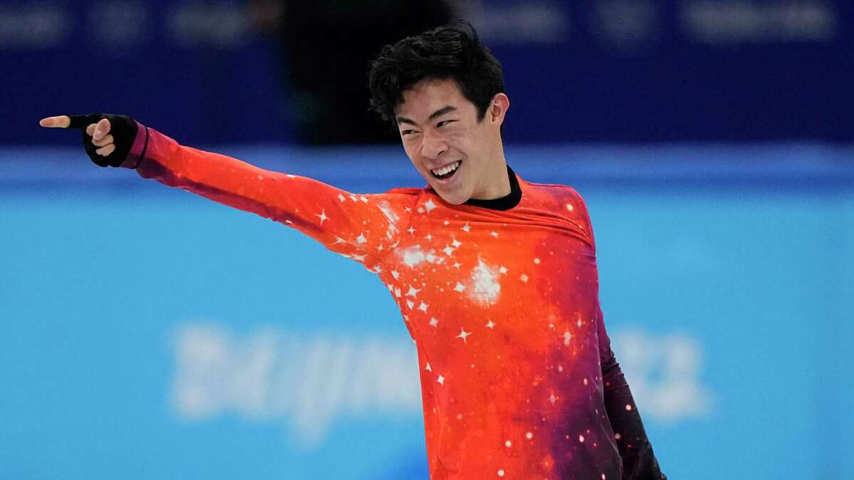 Nathan Chen of the United States hits the ending pose in his ‘Rocket Man’ program and wins gold in men’s figure skating at the 2022 Winter Olympics in Beijing on Feb. 10.
