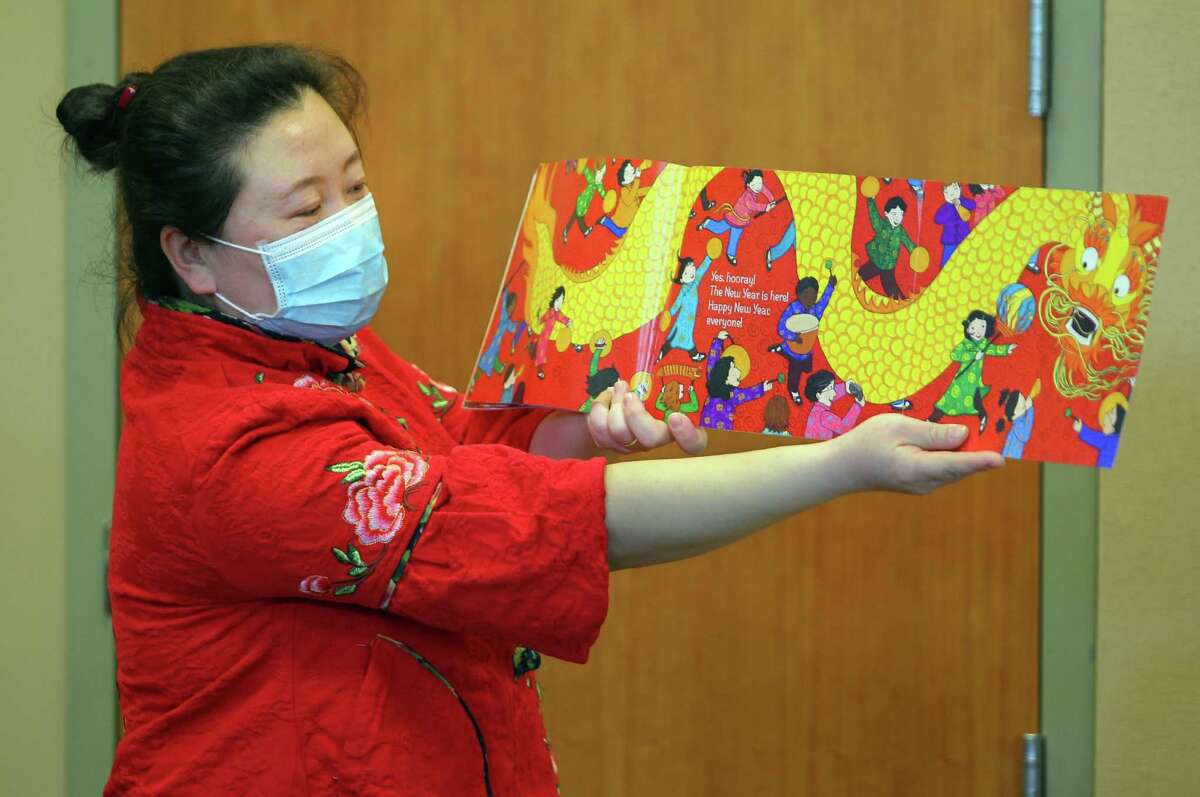 Xiaoxi Song reads to children during Mandarin Storytime at a gathering for a Lunar New Year celebration at Cos Cob Library in Greenwich, Conn., on Saturday February 12, 2022. The event also featured crafts and a demonstration of a southern Chinese Martial Art called Wing Tsun by members of the Club Kung Fu.