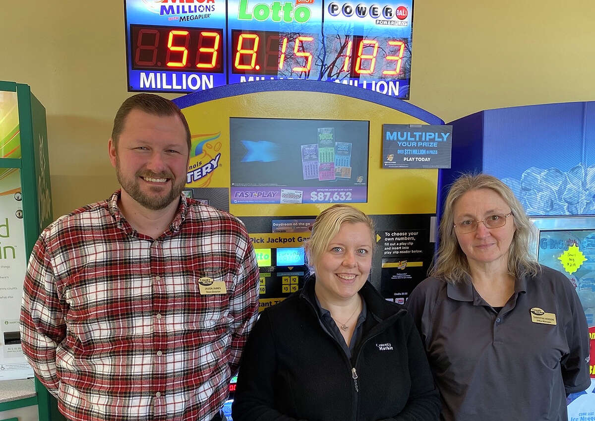 Jason James (left), store director of County Market in Girard, takes a celebratory photo with a few of his staff after selling a $2 million winning Powerball ticket.