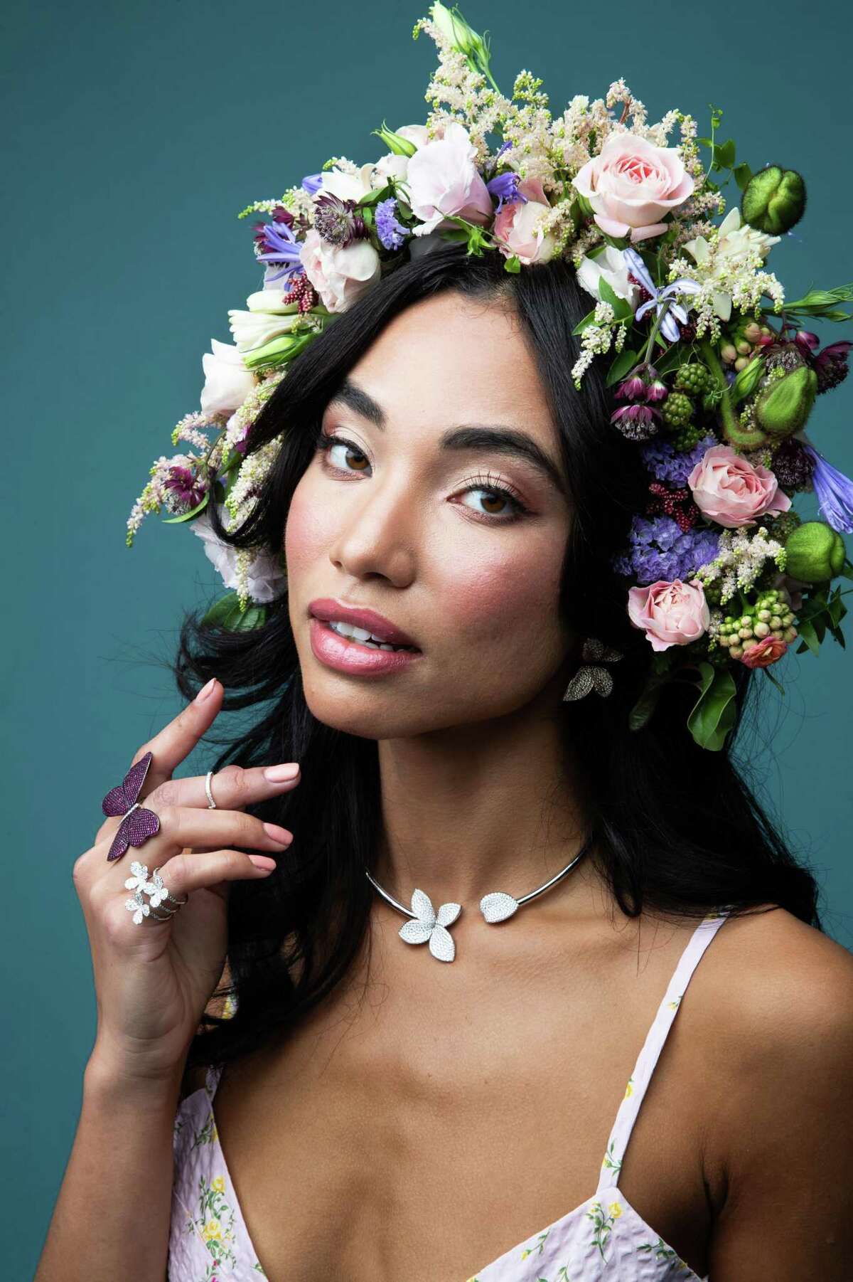 Gabriella wears a bustier mini dress ($595) by Soft Animal with Pasquale Bruni Giadini Segretti earrings ($21,500) and necklace ($28,700) from Zadok Jewelers and a custom Ace Berry headpiece ($300) from Fulshear Floral Design.