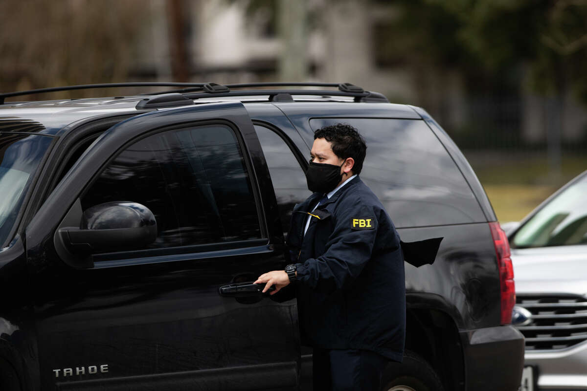 An FBI personnel enters a vehicle after walking out from inside the Houston Health Department, Wednesday, Feb. 16, 2022, in Houston.