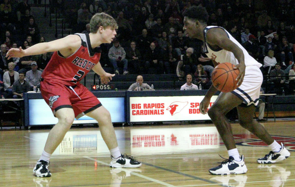 Reed City sophomore Max Hammond (left) guards Big Rapids senior Demarcus Lee on Tuesday evening.