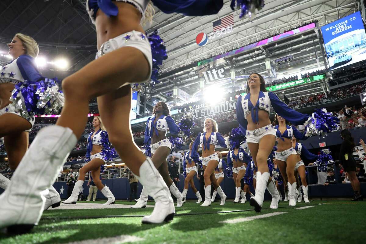 The Dallas Cowboy Cheerleaders enter before San Francisco 49ers' 23-17 win during NFL NFC Wild Card Playoff game at AT&T Stadium in Arlington, Texas on Sunday, January 16, 2022.
