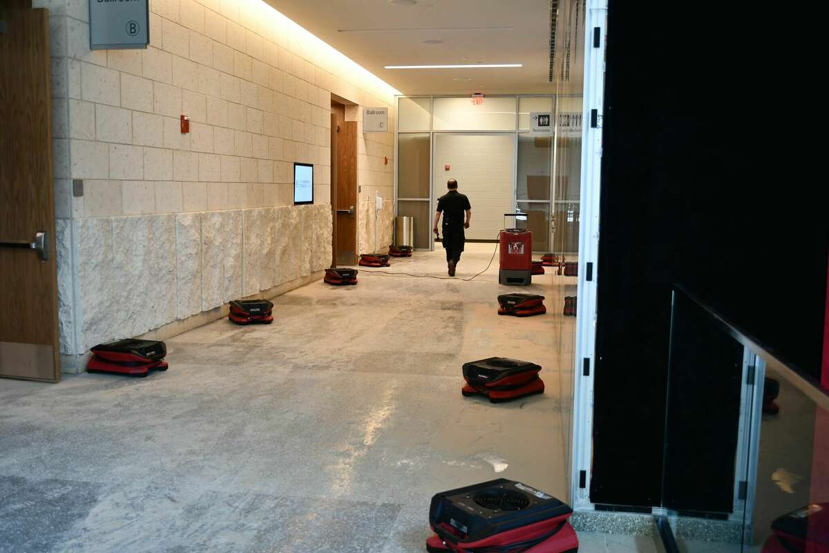 Workers continue dry and clean out the Bush Convention center in February after a water main broke at the south end of the building. 