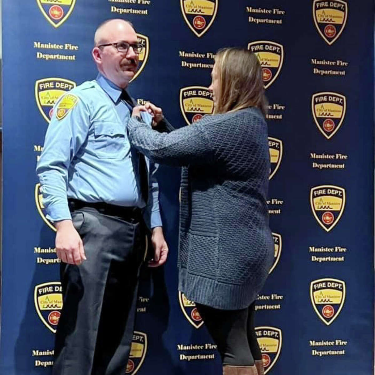 Tuesday evening, Chris Jeffries’ wife Erica Jeffries performs the pinning ceremony switching his silver badge to brass representing the change of going from firefighter-paramedic to captain. 