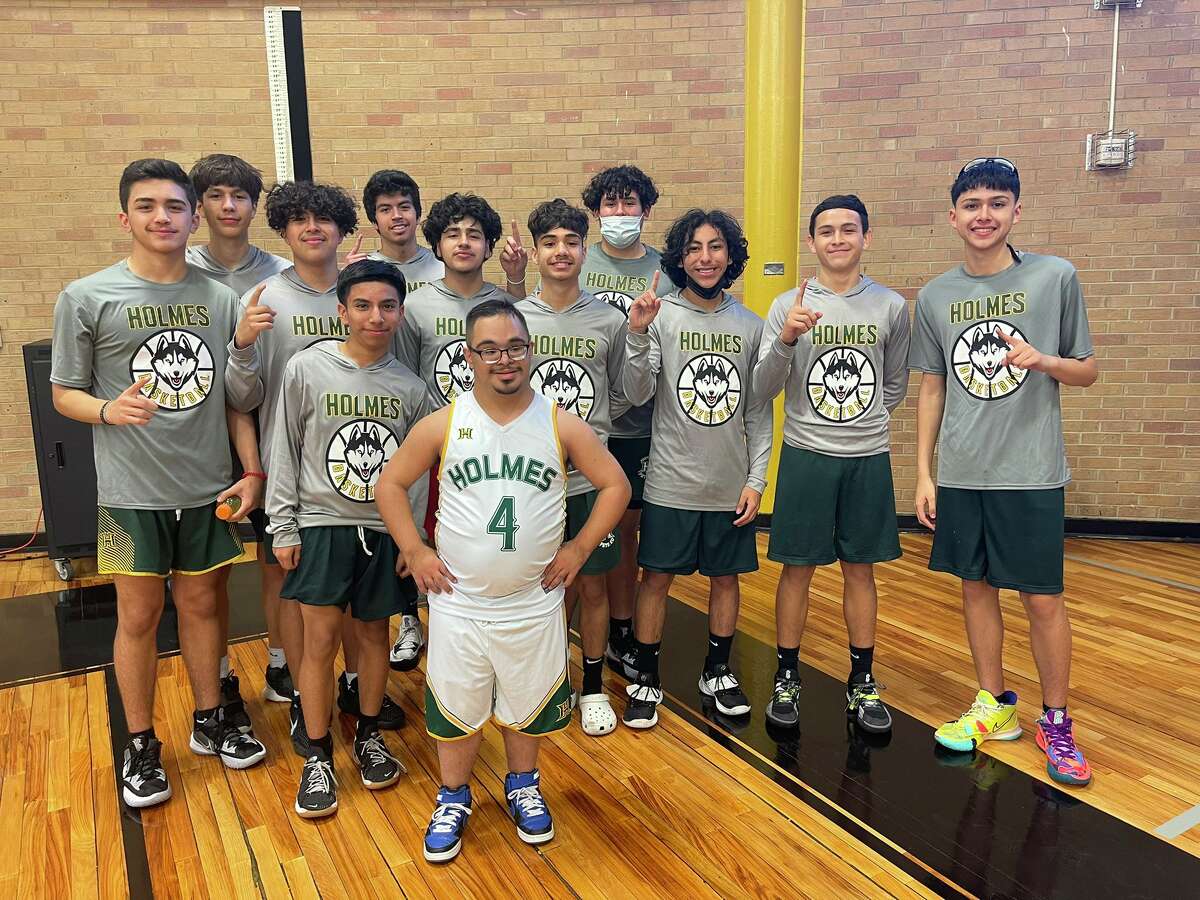 Joaquin Zamarripa (in white) is pictured with Holmes' High School junior varsity basketball team who showed up to support him and the rest of the freshman team during their final game of the season.
