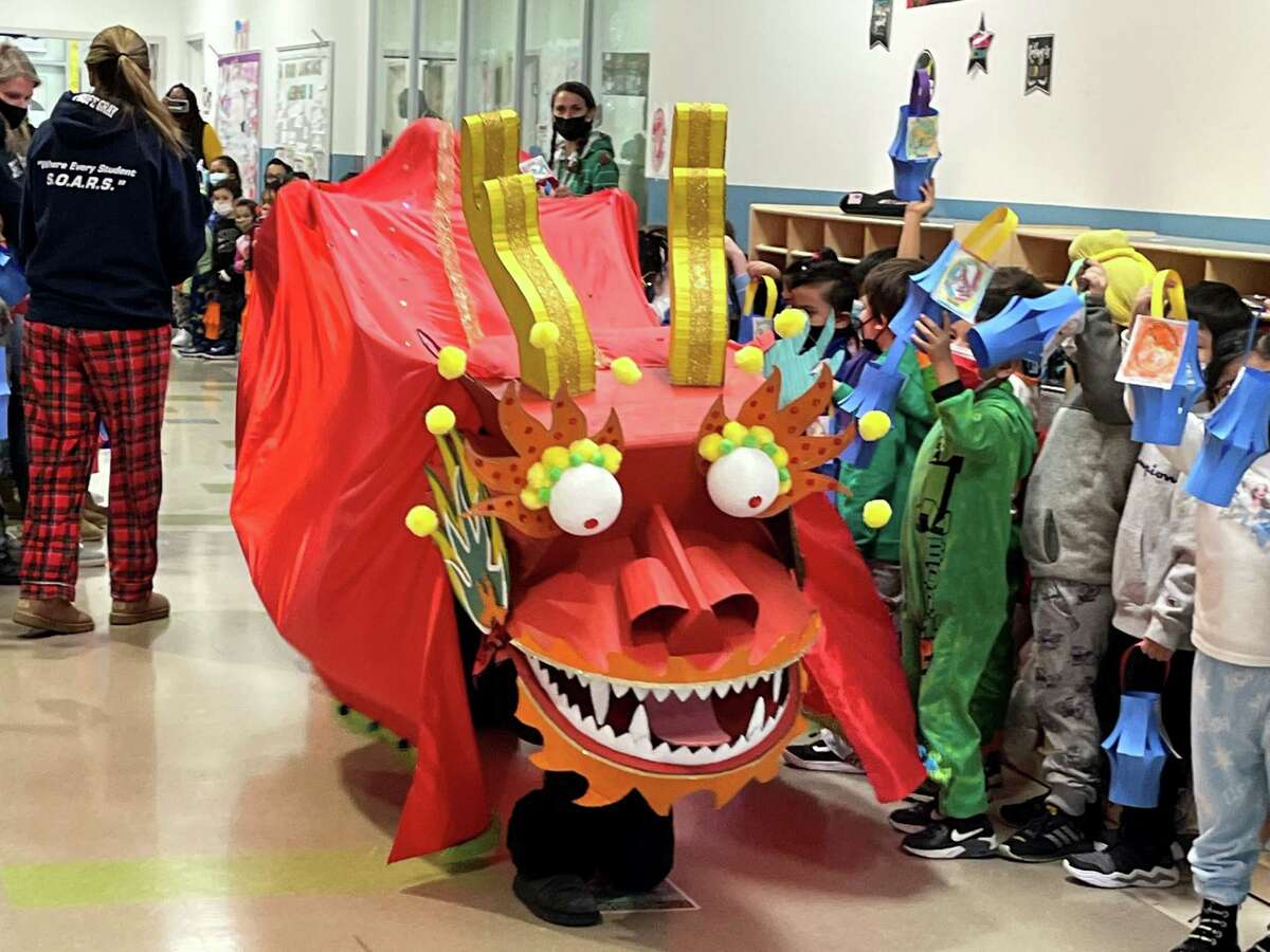 Jen Hodge, an MLL teacher at Jefferson Elementary, controlled the head of the dragon during the parade on Feb. 15, 2022. Art teacher John Hungaski built the dragon with his wife Elsa.