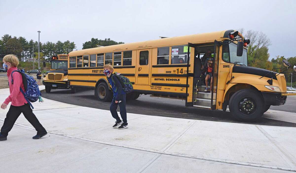Students head into Ralph M. T. Johnson Elementary School in Bethel, Conn., with masks on in September 2020.