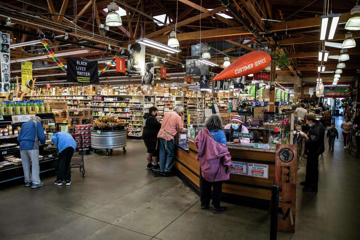 Customers shop inside Rainbow Grocery in San Francisco on Wednesday, Feb. 16, 2022.
