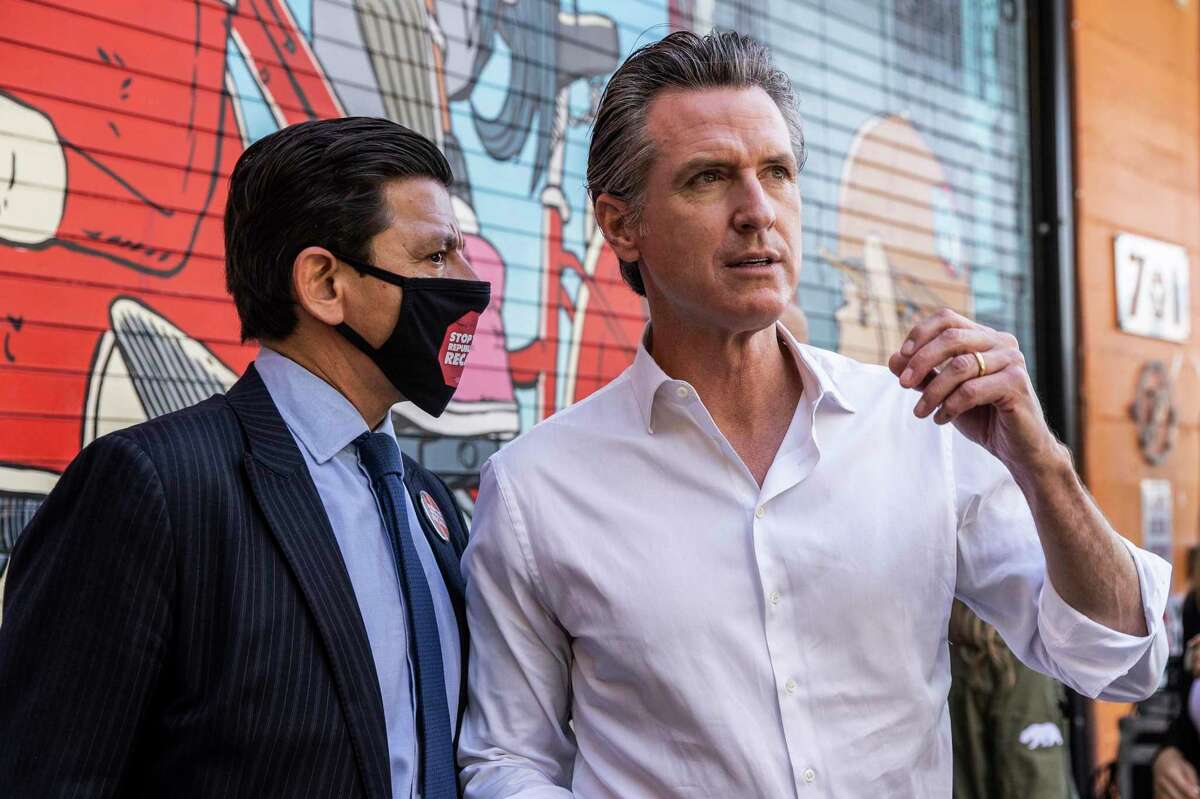 San Francisco Assessor-Recorder Joaquín Torres, left, speaks to California Governor Gavin Newsom, right, during a campaign visit against the upcoming gubernatorial recall election at Mission Language and Vocational School in San Francisco, California Tuesday, Sept. 7, 2021.