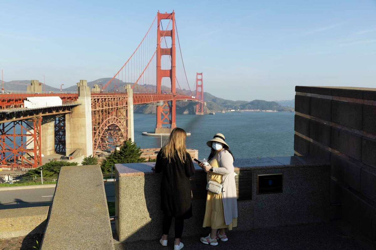Katie Perkins (left) and Rayo Velasco visit the Golden Gate Bridge while in town for a work trip in San Francisco, Calif.