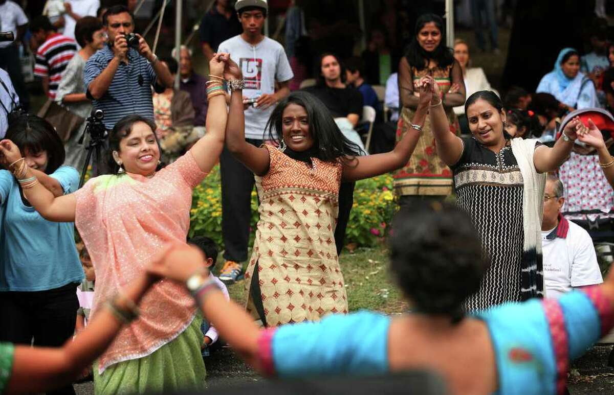 Mousumi Bhaattadarya, left of Fairfield, teaches an Indian circle dance at the Hindu Cultural Center of Connecticut's annual Heritage India Festival on the Town Hall Green in Fairfield on Sunday, September 28, 2010.