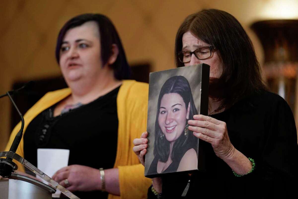 While Hannah D’Avino, left, speaks, Mary D’Avino holds a picture of her daughter Rachel, who was killed in the 2012 massacre at Sandy Hook Elementary School in Connecticut. Twenty people were shot dead, including 20 first-graders.