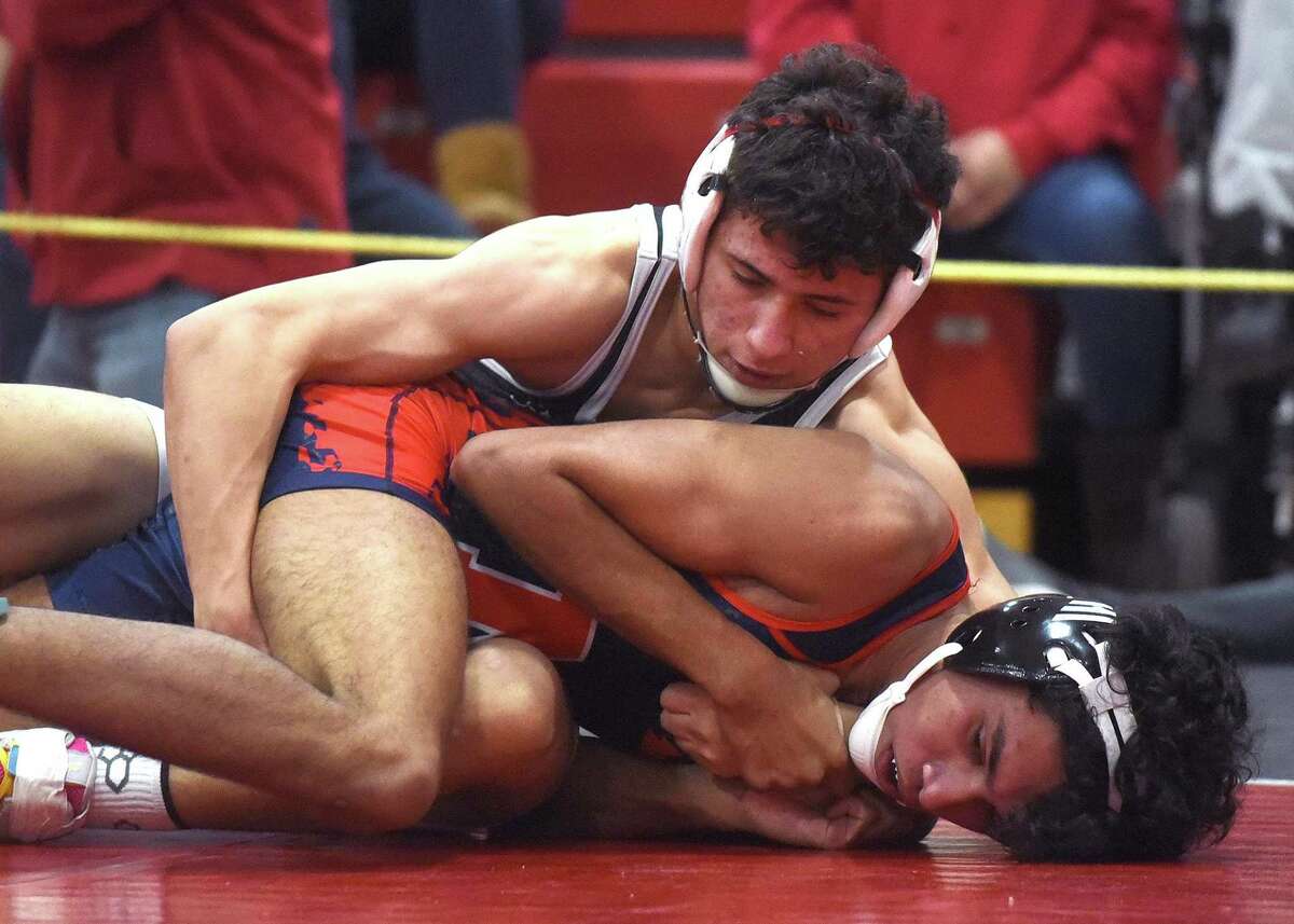 New Canaan's RJ DeCamillo, top, wrestles McMahon's Camilo Ham in the 138-pound quarterfinals at the FCIAC tournament in New Canaan on Friday, Feb. 11.