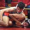 New Canaan's RJ DeCamillo, top, wrestles McMahon's Camilo Ham in the 138-pound quarterfinals at the FCIAC tournament in New Canaan on Friday, Feb. 11.