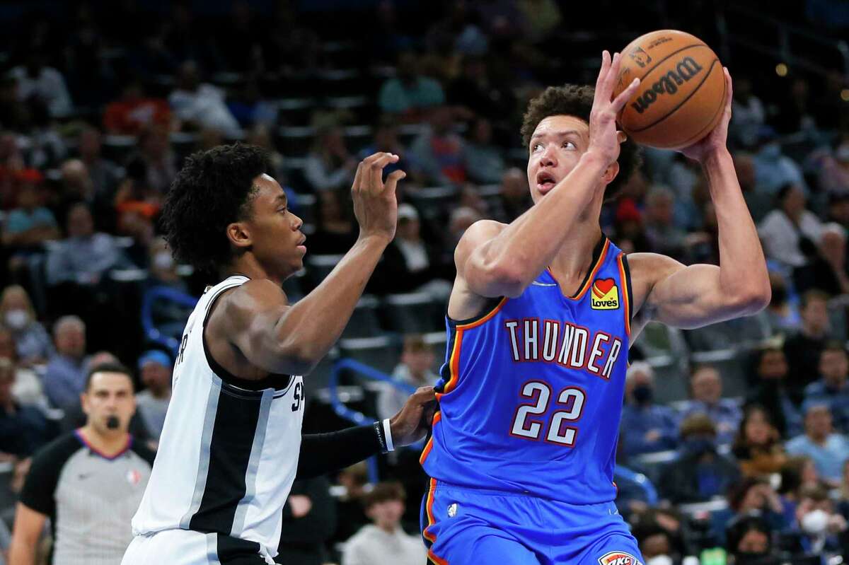Oklahoma City Thunder forward Isaiah Roby (22) holds the ball as San Antonio Spurs guard Josh Primo, left, defends during the second half of an NBA basketball game Wednesday, Feb. 16, 2022, in Oklahoma City. (AP Photo/Nate Billings)