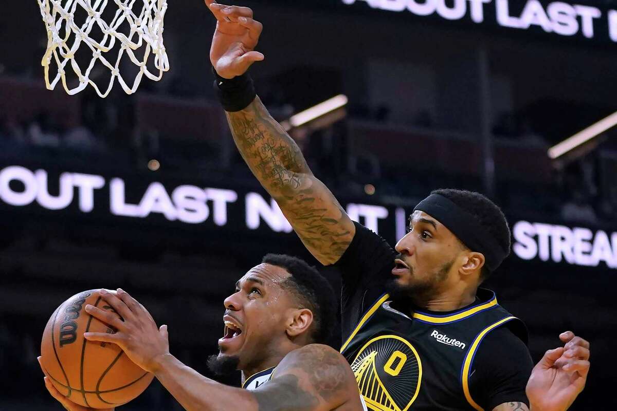 Denver Nuggets guard Monte Morris (11) shoots against Golden State Warriors guard Gary Payton II during the first half of an NBA basketball game in San Francisco, Wednesday, Feb. 16, 2022. (AP Photo/Jeff Chiu)
