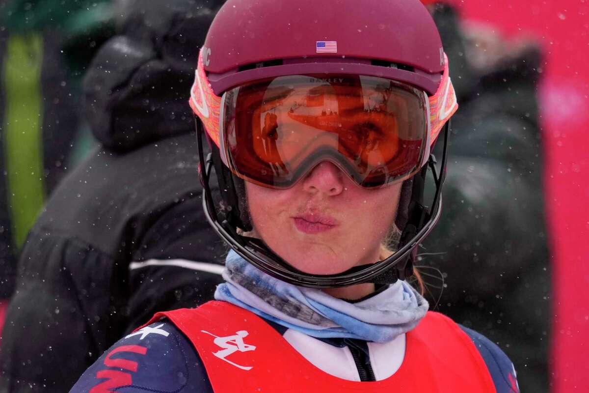 Mikaela Shiffrin, of the United States, gestures after falling in the women's combine slalom at the 2022 Winter Olympics, Thursday, Feb. 17, 2022, in the Yanqing district of Beijing. (AP Photo/Luca Bruno)