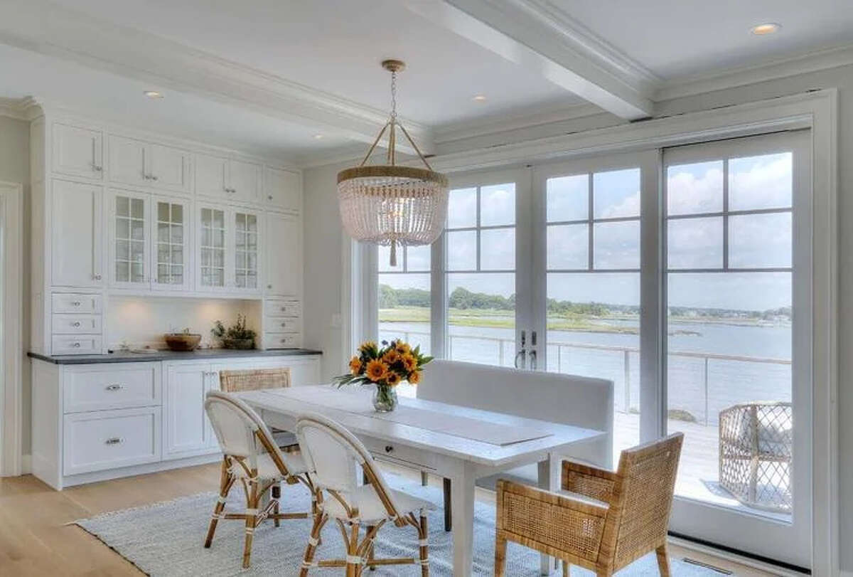 Besides plentiful outside views, the first-floor living and dining rooms and kitchen are open, and feature soft colors and patterns that reflect coastal New England and let those beachy vistas stand out.