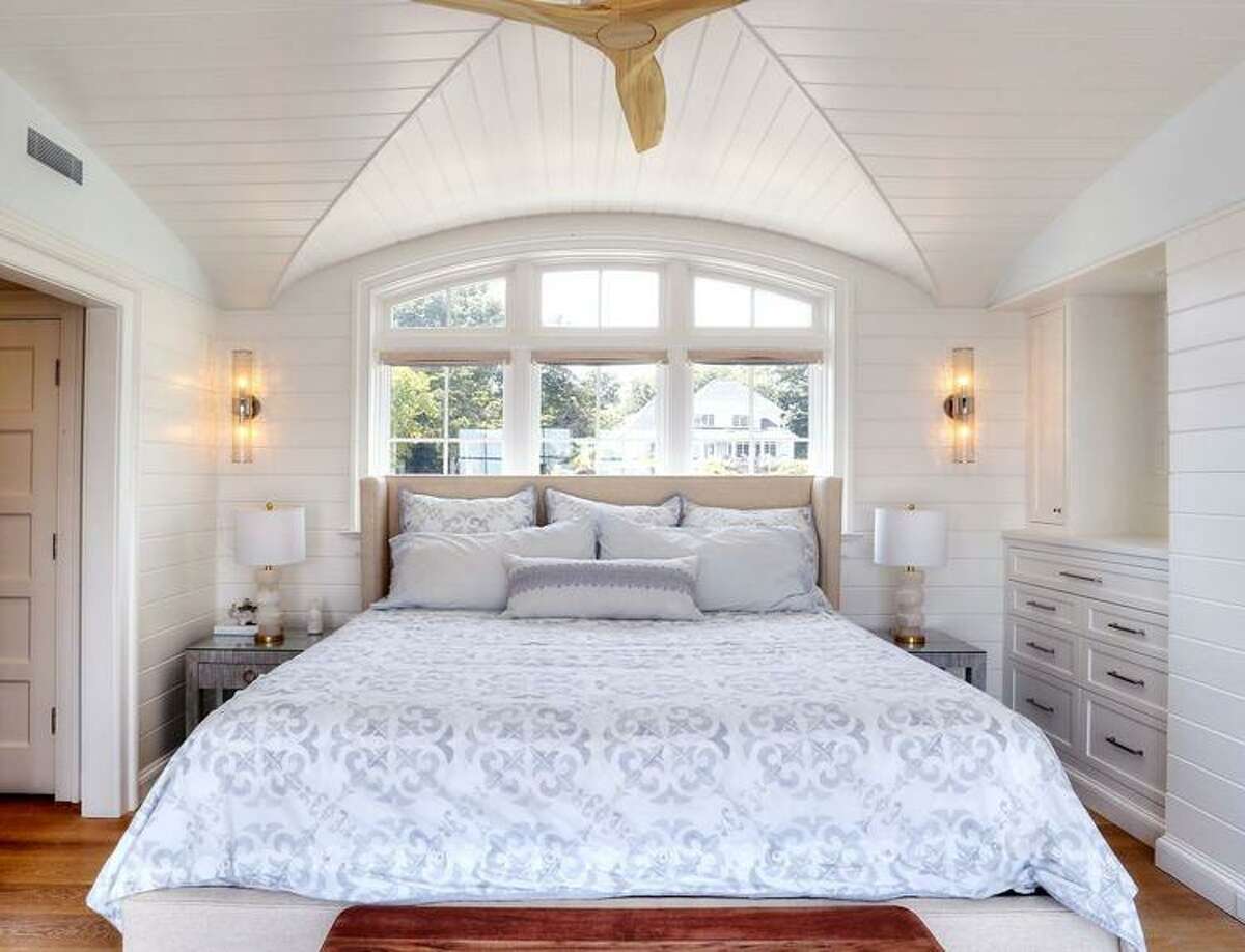 The master bedroom is an example of architect Russ Campaigne’s thoughtful design, as he used bay-window space for the bed and created a sitting area.