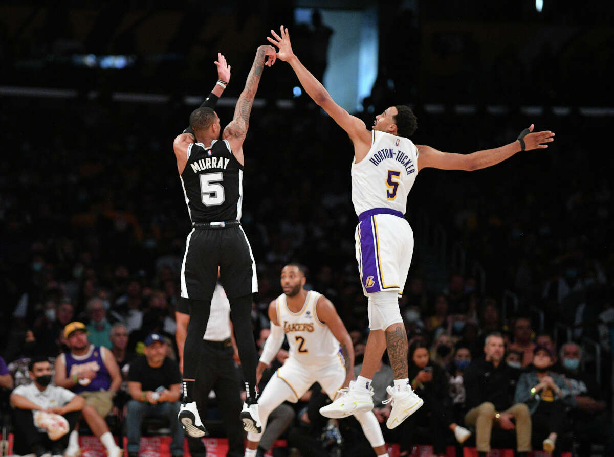 LOS ANGELES, CALIFORNIA - NOVEMBER 14: Dejounte Murray #5 of the San Antonio Spurs shoots over Talen Horton-Tucker #5 of the Los Angeles Lakers during the second half at Staples Center on November 14, 2021 in Los Angeles, California. 