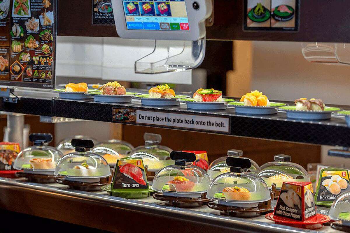 Kura Revoling Sushi Bar delivers food to customers on a double conveyor belt system.