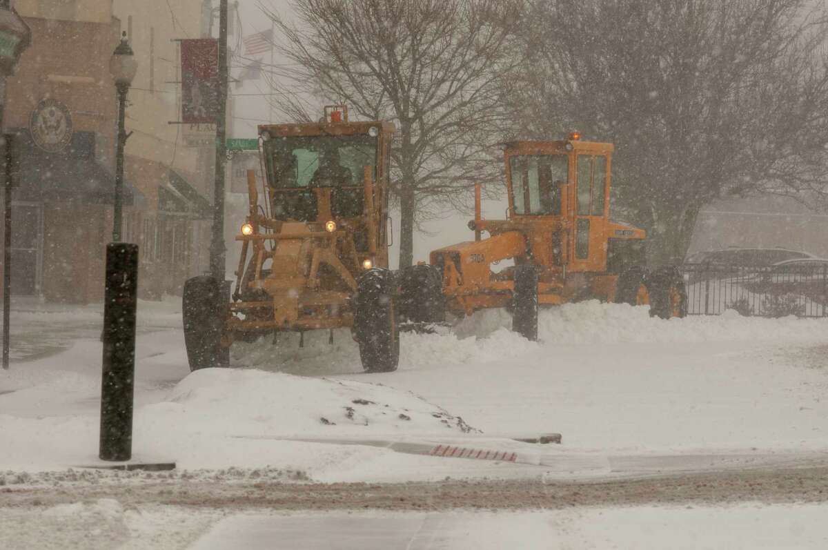 Crews work Thursday to clear snow from the downtown Jacksonville square.