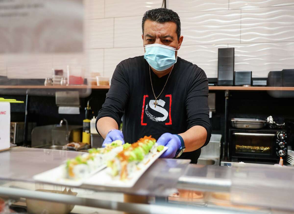 Sushi assistant Jorge Hernandez wears a mask at Sushi Confidential in Campbell in January.