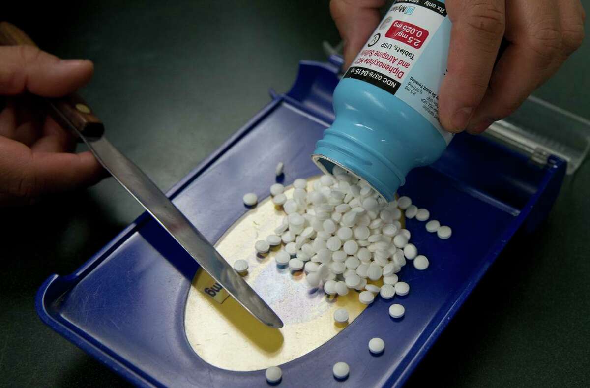 In this file photo, a pharmacist technician in Sacramento fills a prescription.