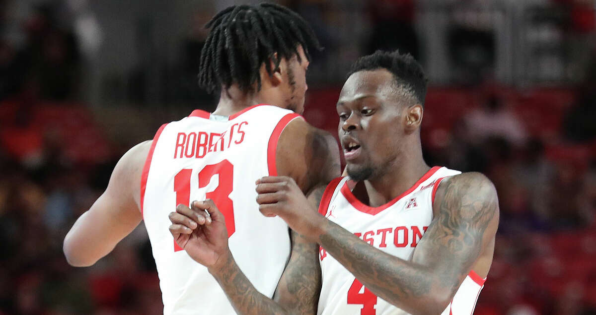 Houston Cougars forward J'Wan Roberts (13) and guard Taze Moore (4) react after Houston took the lead during the second half of an NCAA men's basketball game at Fertitta Center on the University of Houston Campus, on Thursday, Feb. 17, 2022 in Houston.