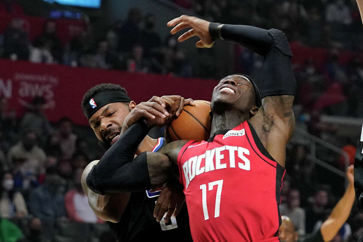 Houston Rockets guard Dennis Schroder, right, is fouled by Los Angeles Clippers' Marcus Morris Sr. during the first half of an NBA basketball game Thursday, Feb. 17, 2022, in Los Angeles. (AP Photo/Mark J. Terrill)