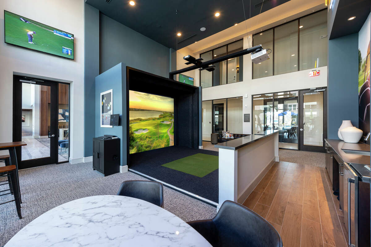 A golf simulator adds to the extensive amenities at Domain Heights.