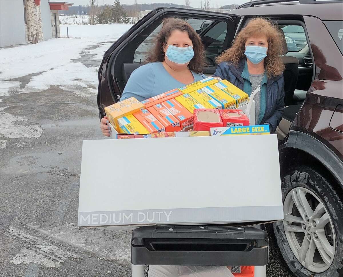 (From left) Tina Clark and Chris Harper from Martin Marietta deliver a large donation of food for the senior food pantry. Fellow employees contributed to the fund.