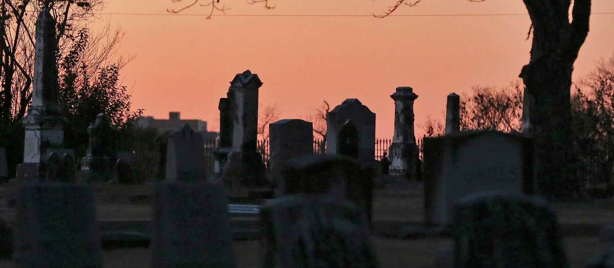 The sun sets at San Antonio’s City Cemetery No. 1 as Stephen and Fred Garza-Guzman of Curious Twins Paranormal host a cemetery tour designed to educate people about the city’s history.