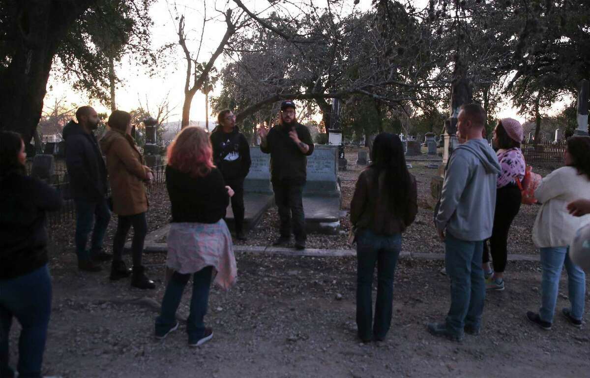 Stephen and Fred Garza-Guzman of Curious Twins Paranormal start a tour of City Cemetery No. 1 on a recent Friday.