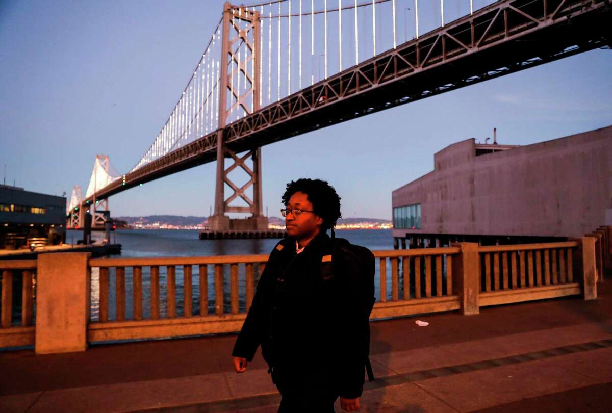 Chaplain Jessica Easter walks to the Embarcadero as the sun sets. 