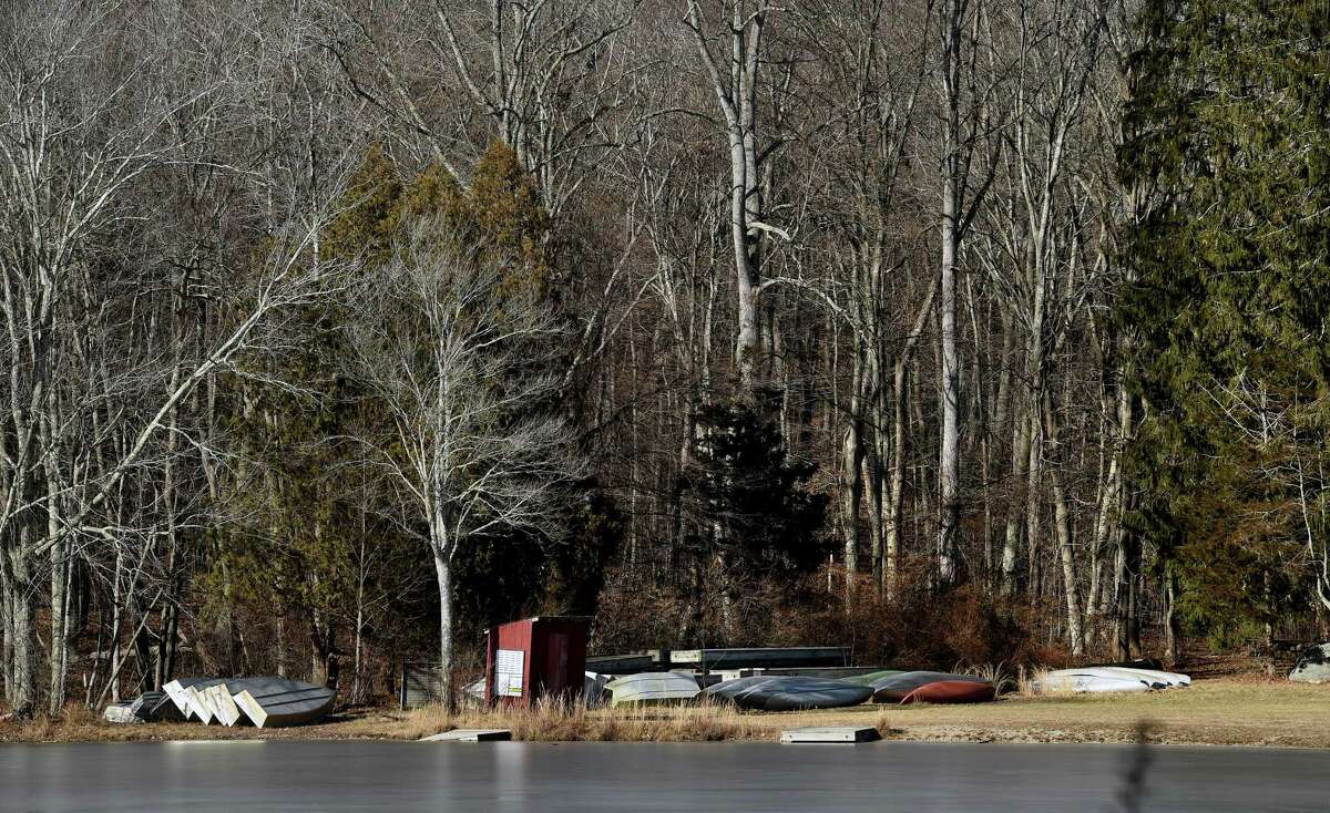Canoes lie dormant at the edge of the lake at Deer Lake Scout Reservation in Killingworth Jan. 27, 2022.